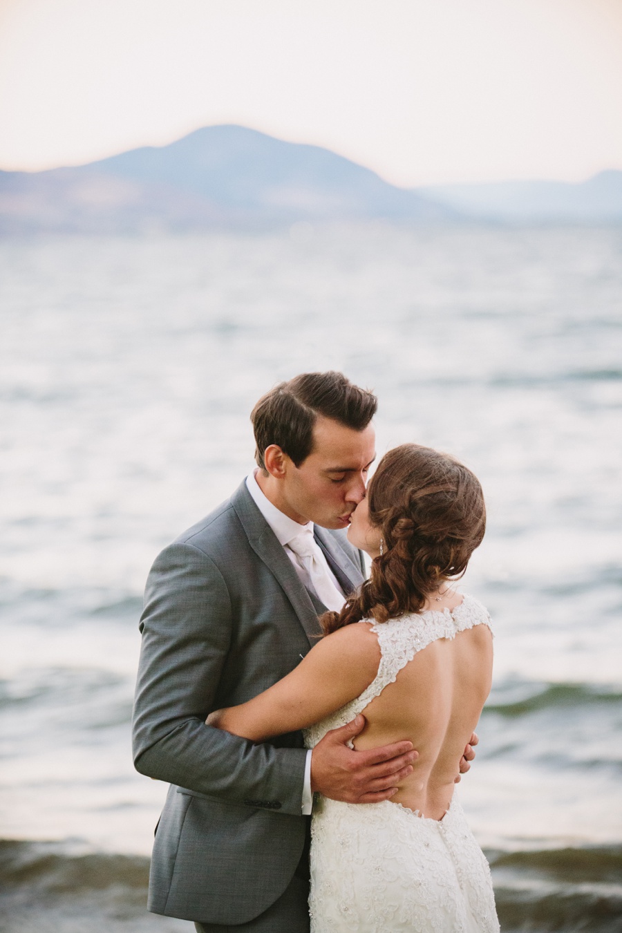 Penticton Bride and Groom Kissing next to lake
