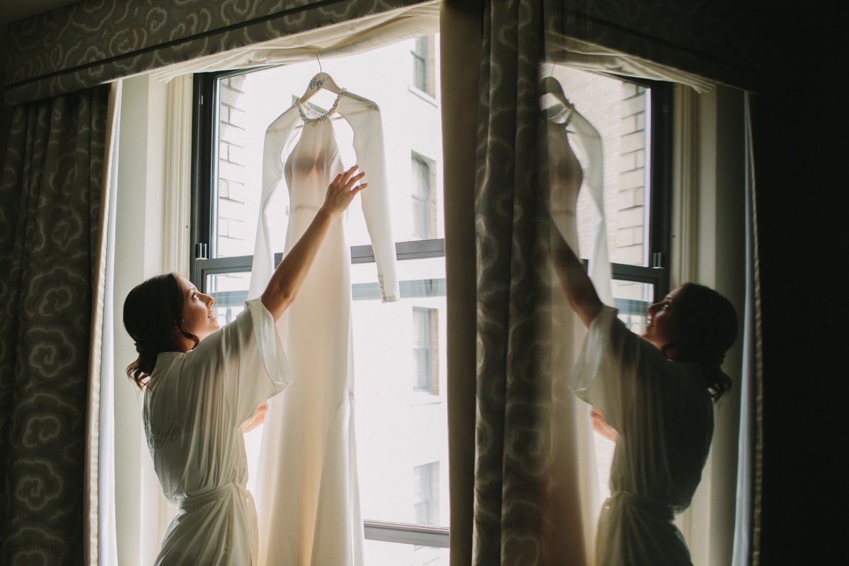 Bride getting into dress at Fairmont Hotel Vancouver