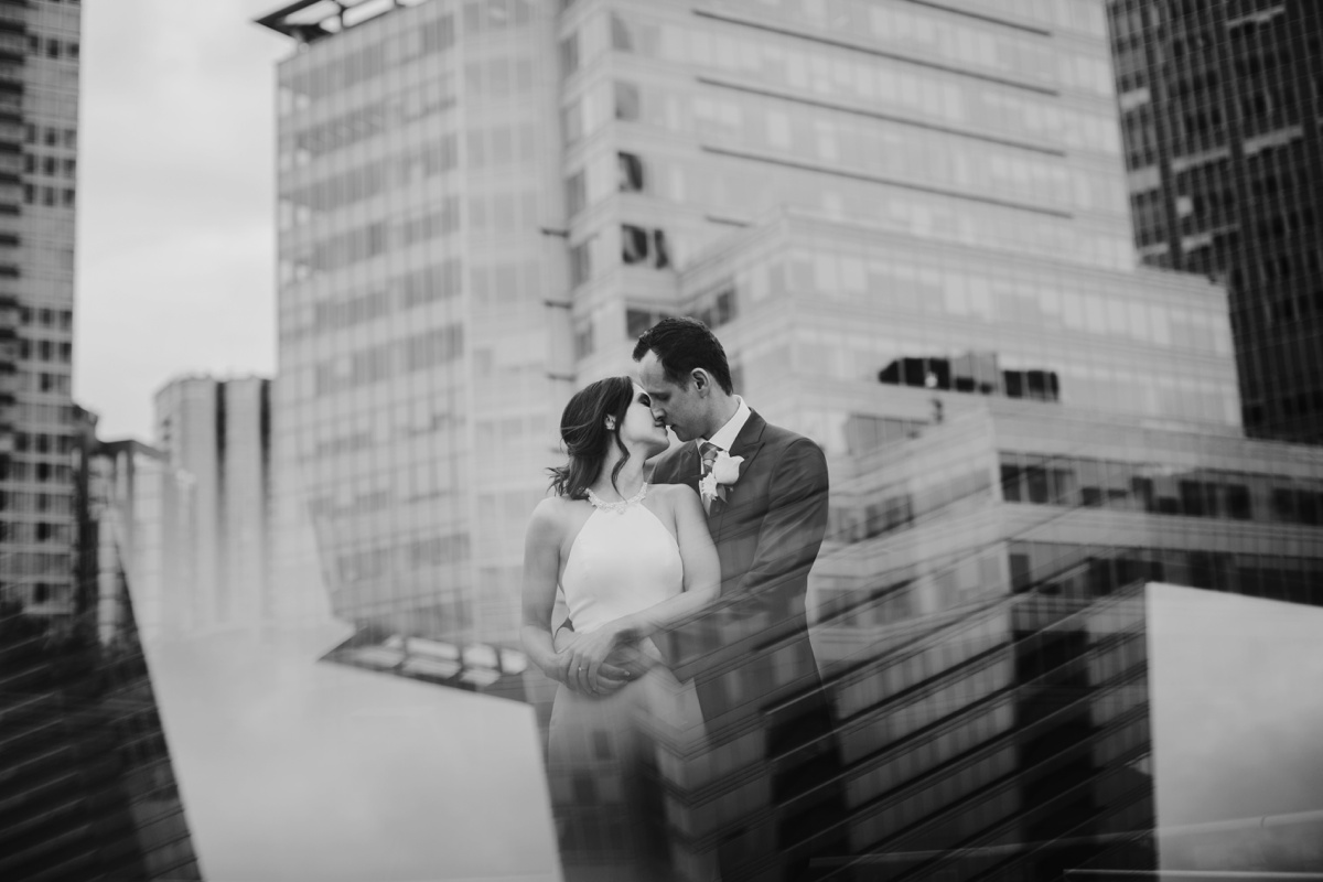 Creative portrait of bride and groom with Vancouver skyline